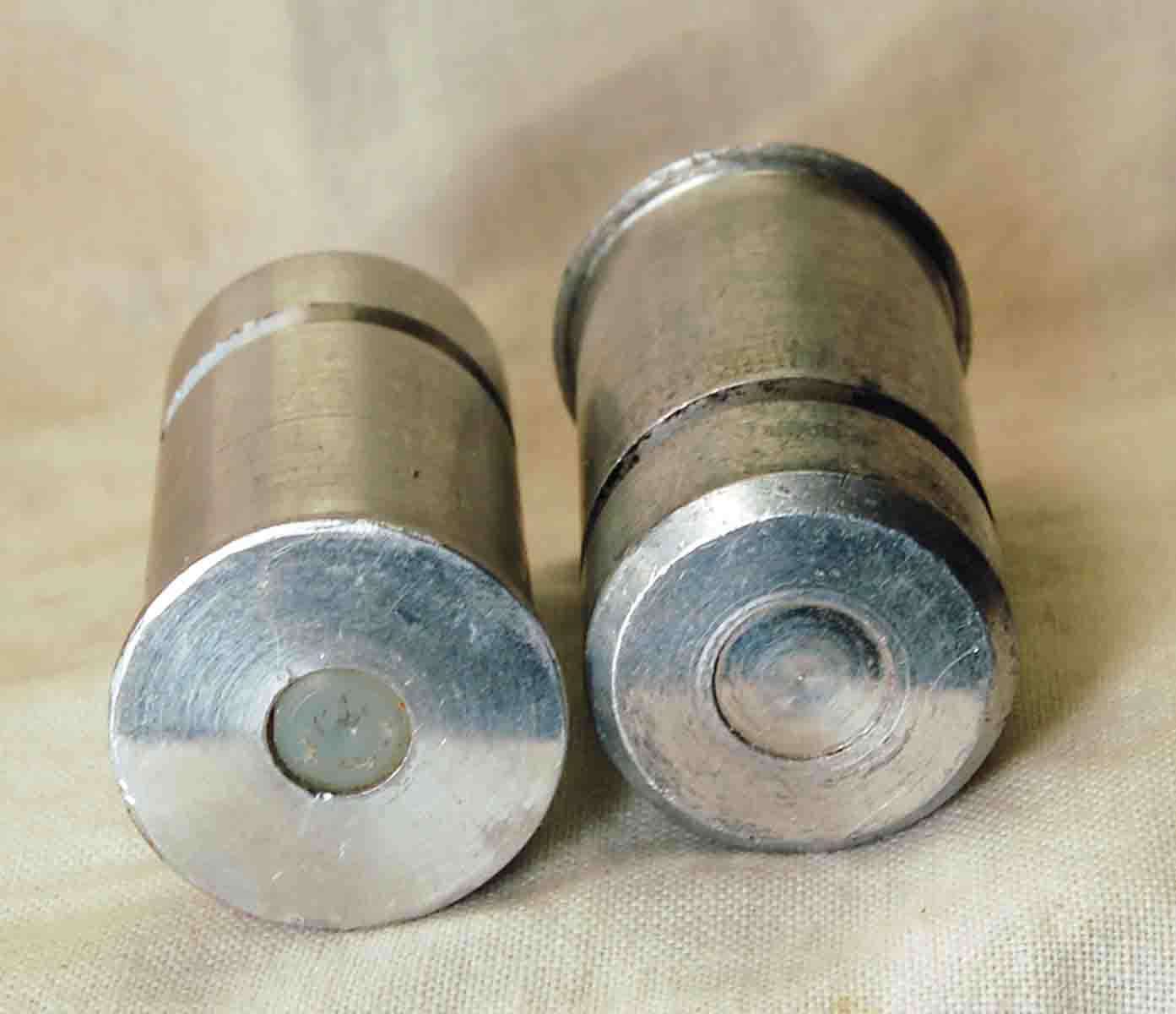 A pair of commercial snap caps with a nylon “primer” (left) and plugged end containing a spring (right).
